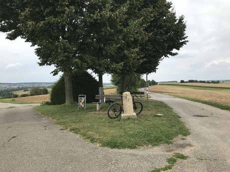 Photo of a place on a hill with a bench, trees and my bike