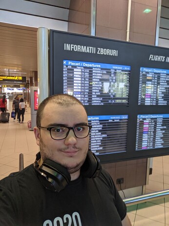 Me, at the OTP airport. Selfie with the departures screen in the background