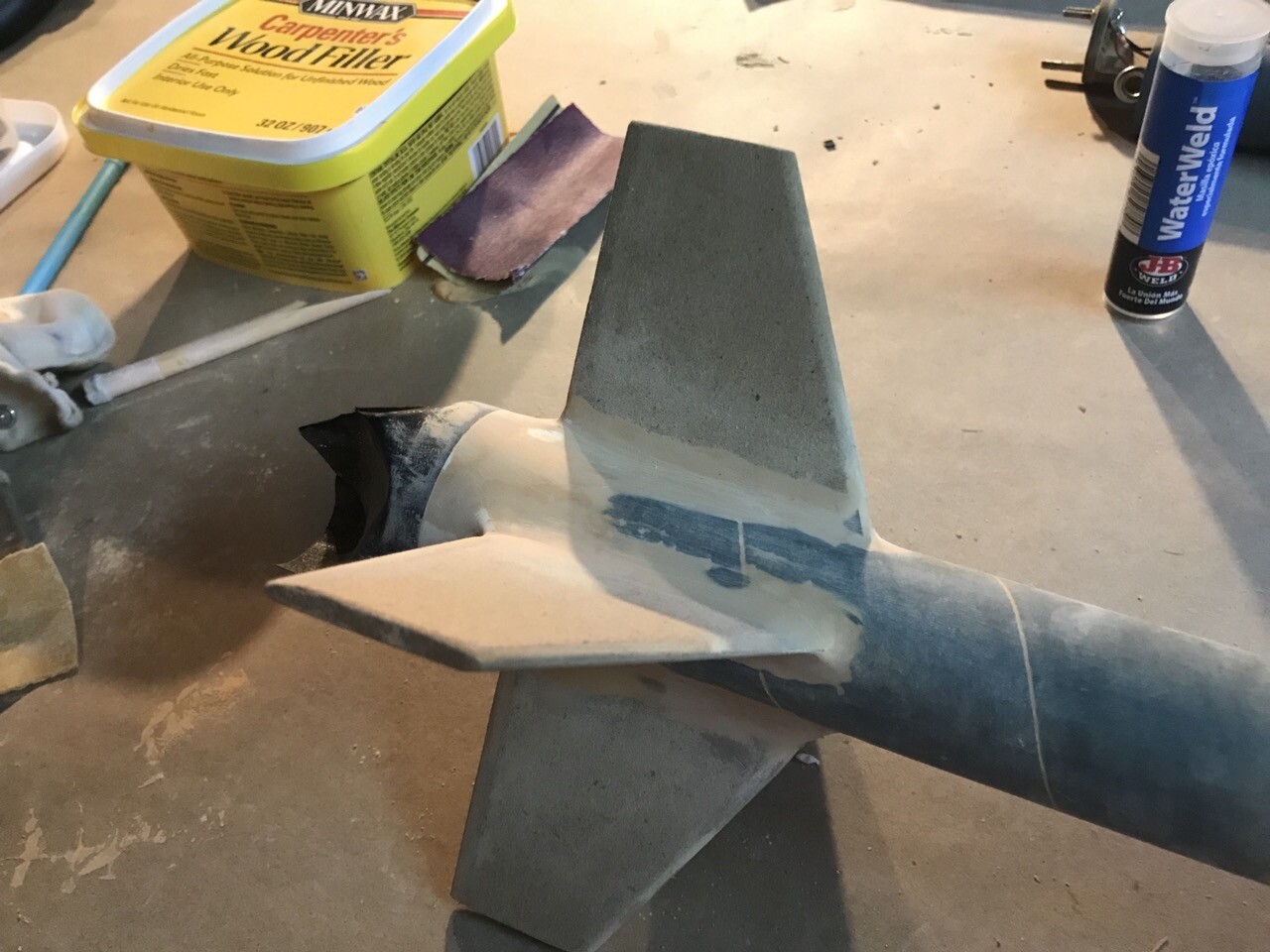 Tail end of rocket with the beginnings of some filler for fin and engine retainer fillets
