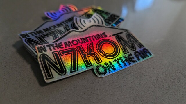 Holographic stickers that read "N7KOM In the mountains, on the air."
