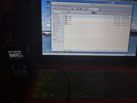 Picture of my TH-D75 connected to a laptop running Linux (Fedora 39). The laptop has a file browser window open, looking at the TH-D75's Lexar 32Gb microSD card. 