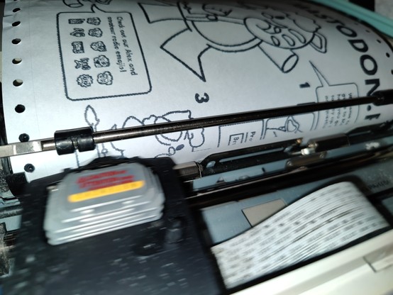Action shot of the printer head blurring as it speeds across stamping Alex onto the page