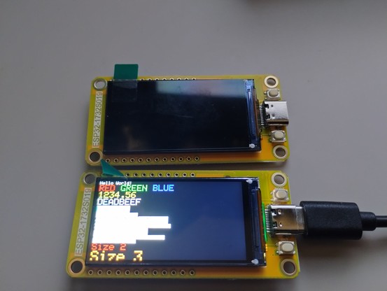 two ESP32-1732S019 (ESP32 S3) boards on yellow PCB, one powered on showing the loaded demo, the other not on.  Both are new