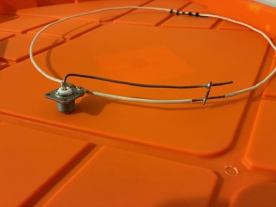 Photograph showing details of the feed and matching. Wire ends are separated by about 1/4" and held in place with a cut-off zip tie length with additional zip ties holding the wire to the separator.