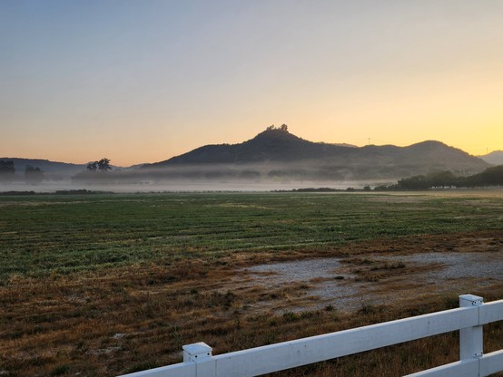 Fog over a meadow at sunrise