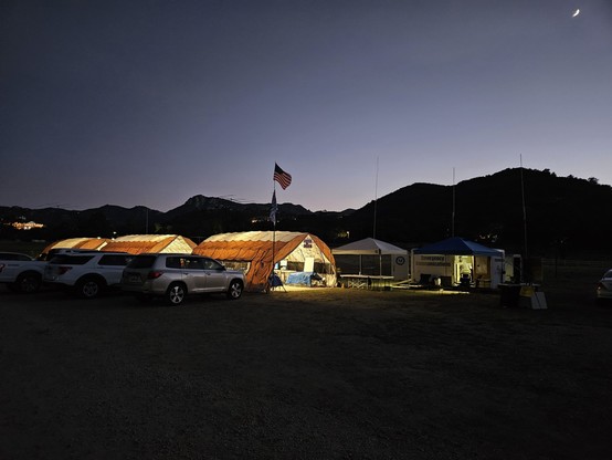 Internally lit Quonset-style tents at dusk